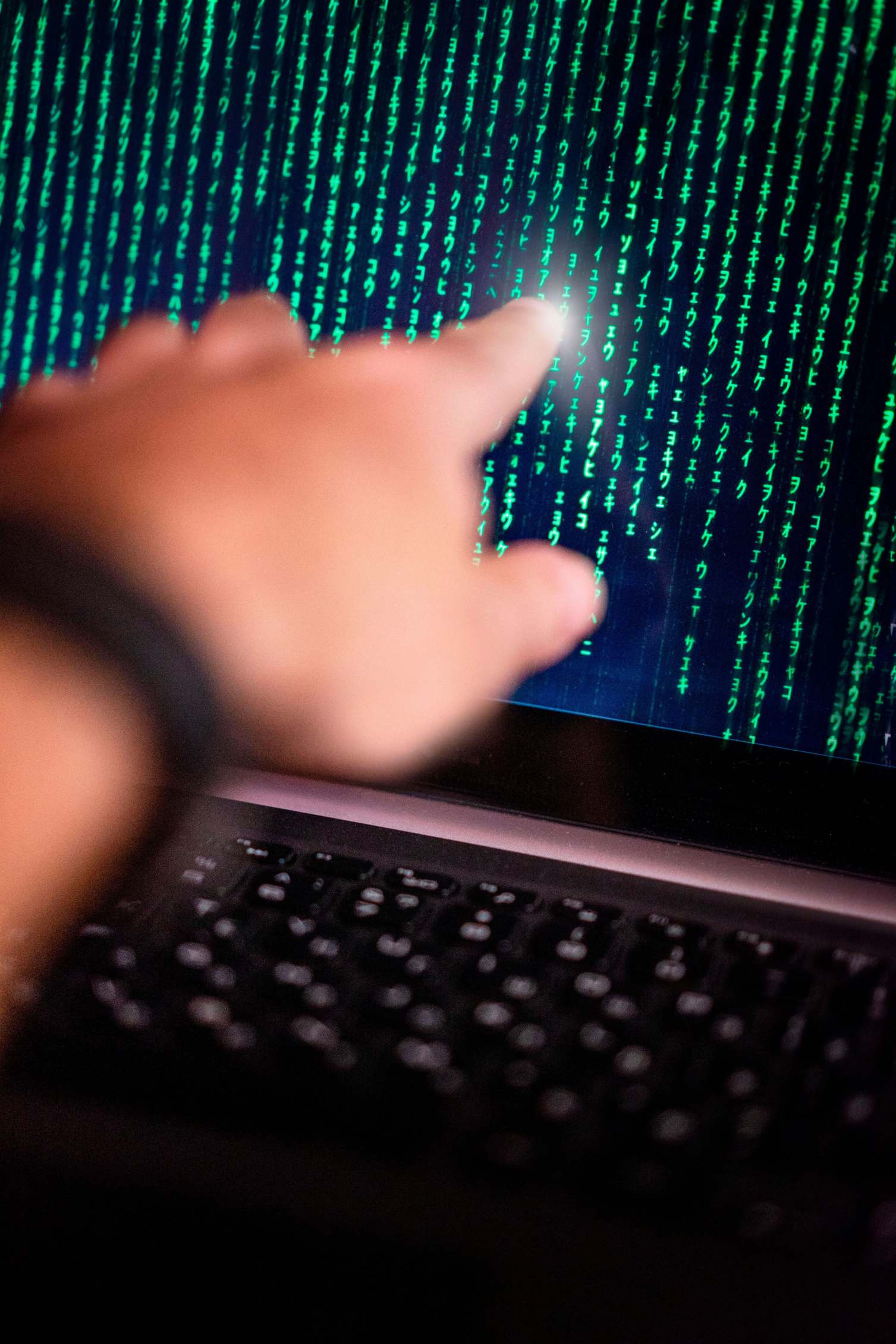 Source code on a computer screen with keyboard